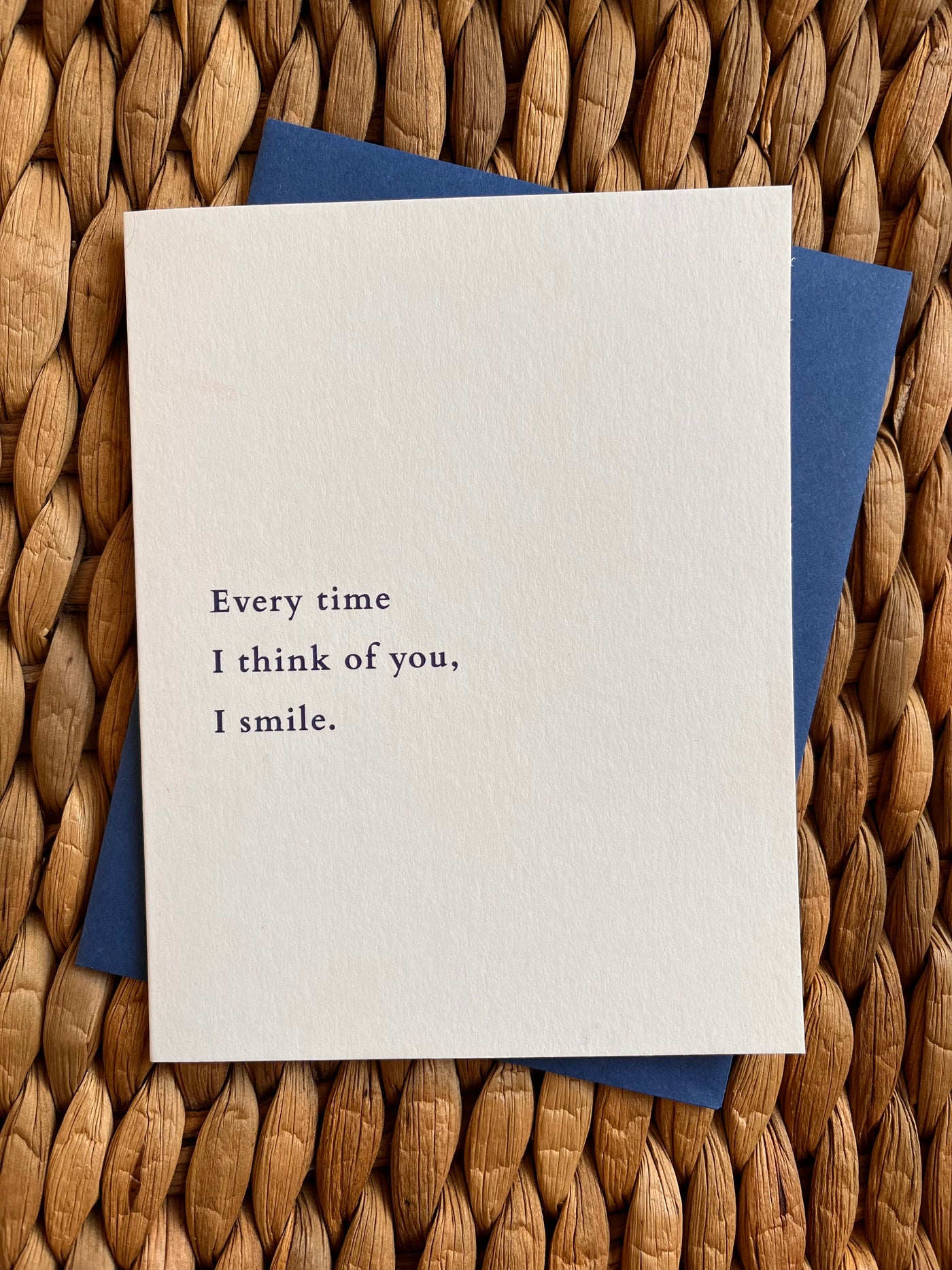 Beknown greeting card with envelope on wood in collaboration with House of Pride, inspired by words from Char Bailey, Every time I think of you, I smile.