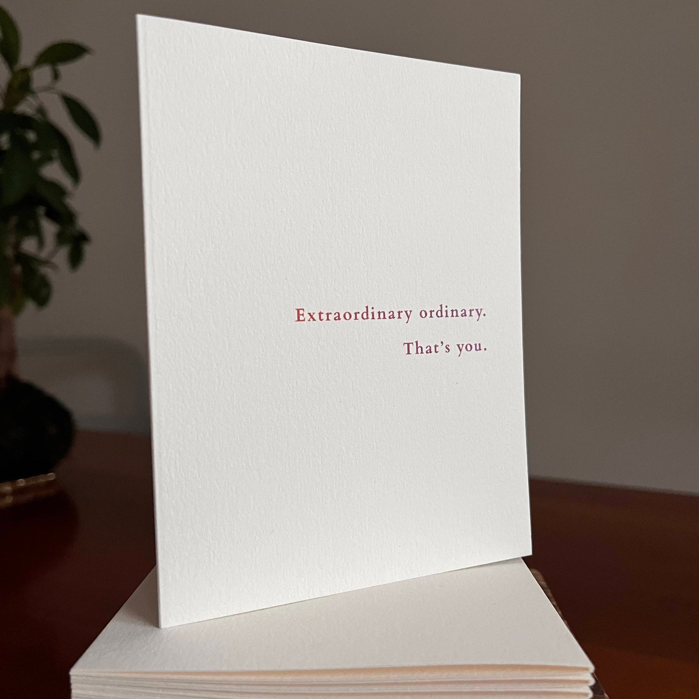Beknown greeting card on stack of cards. Extraordinary ordinary. That's you.