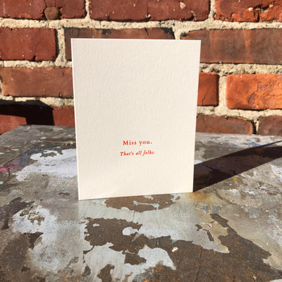 Greeting card on rusted table by beknown. Miss you. That's all folks.
