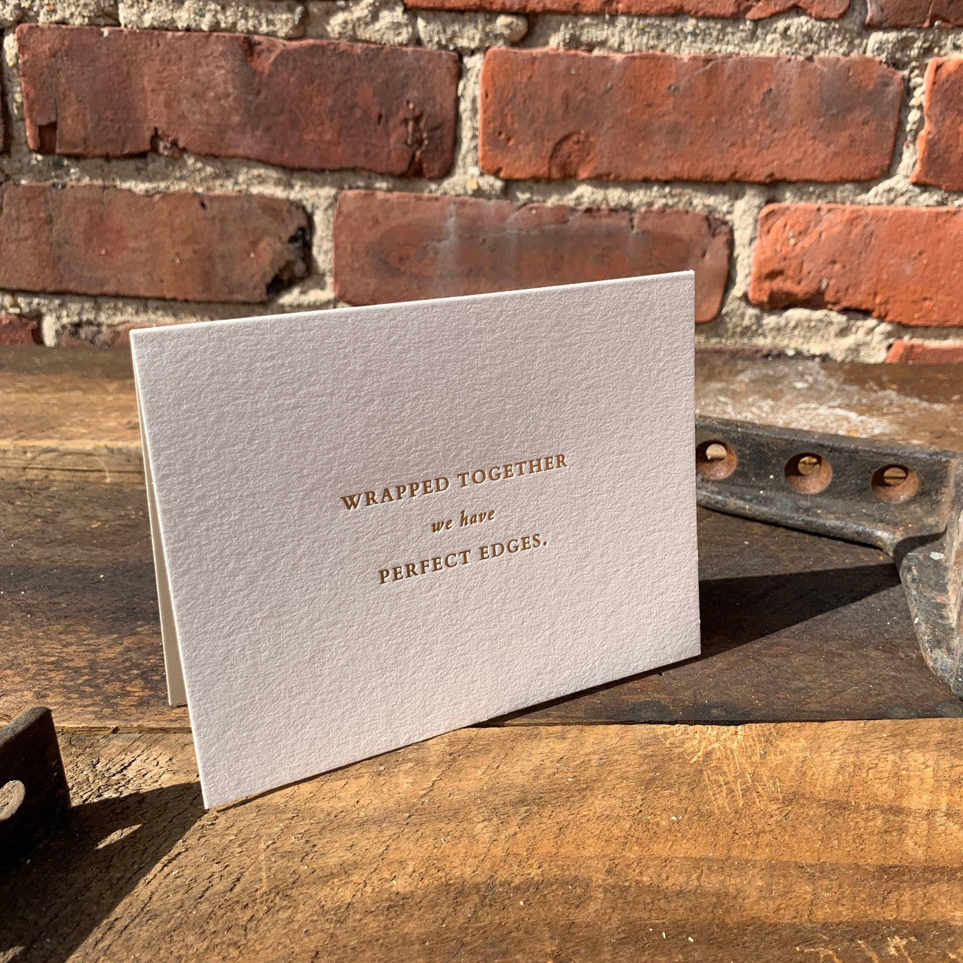 Greeting card on wood table by beknown. Wrapped together we have perfect edges.