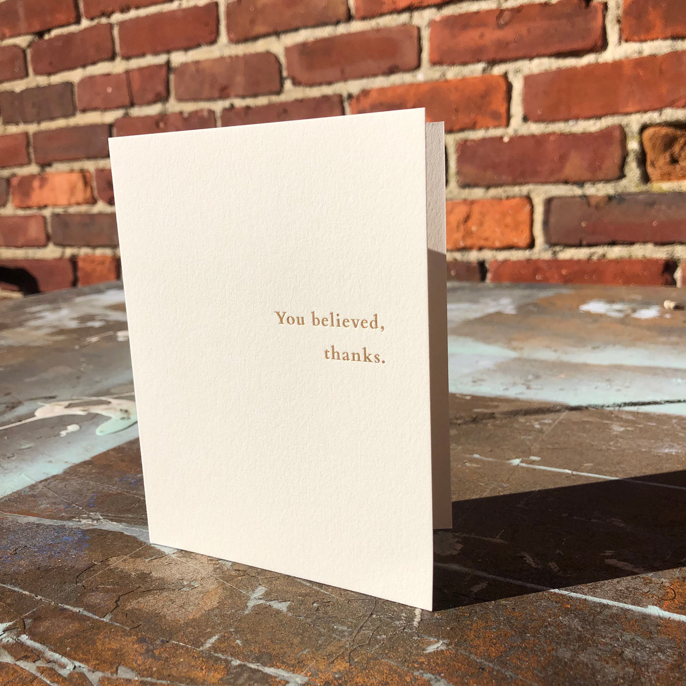 Greeting card on rusted table by beknown. You believed, thanks.