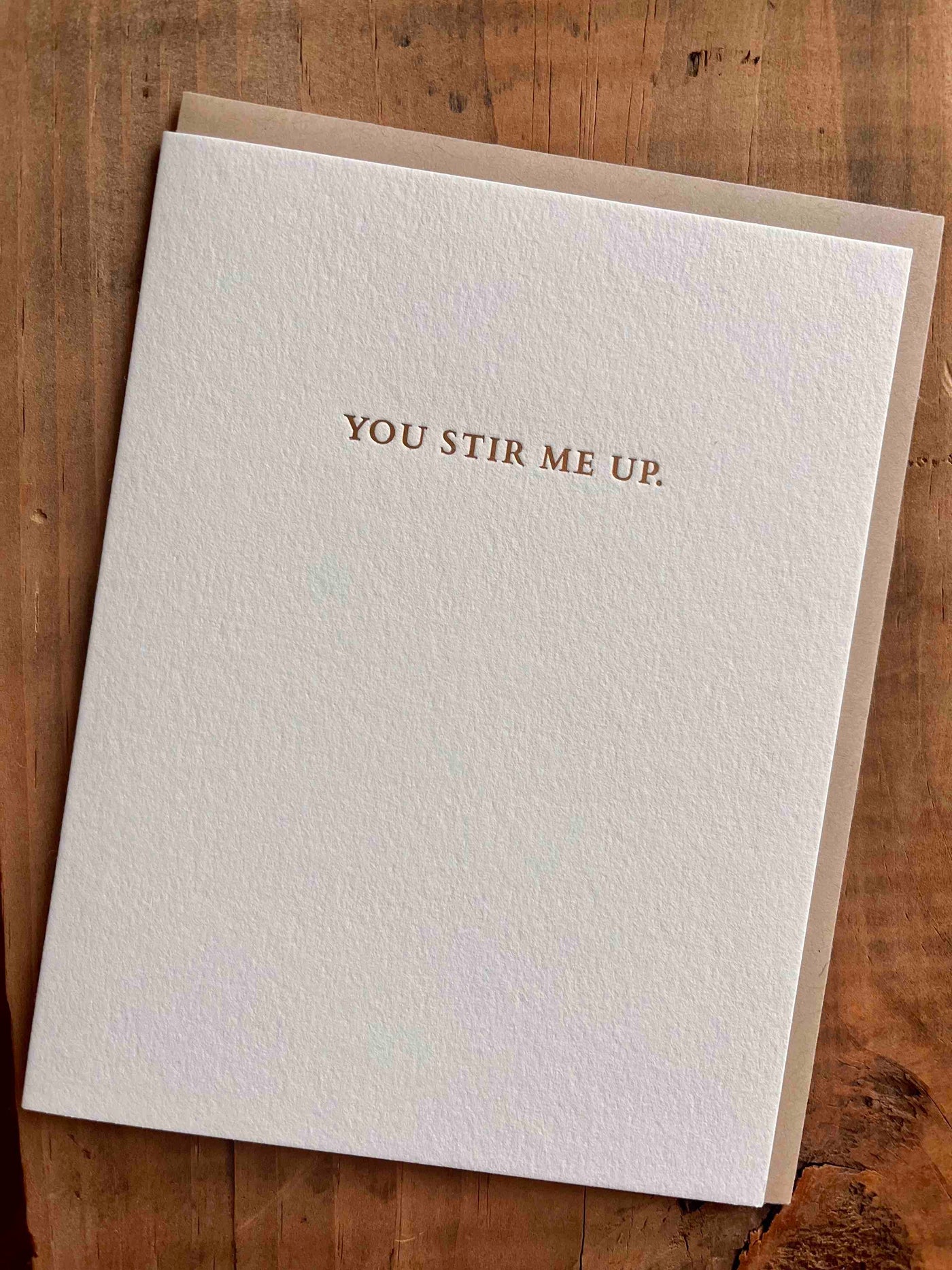 Greeting card on wooden table by beknown. You stir me up