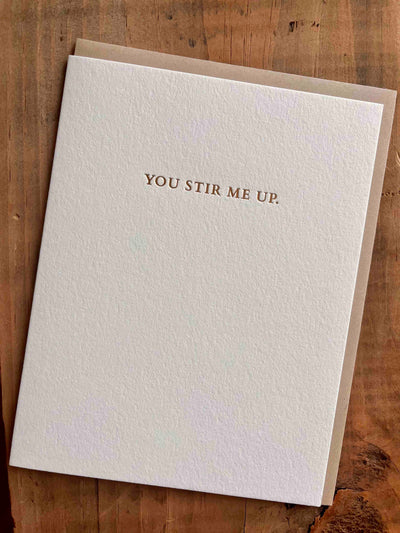 Greeting card on wooden table by beknown. You stir me up